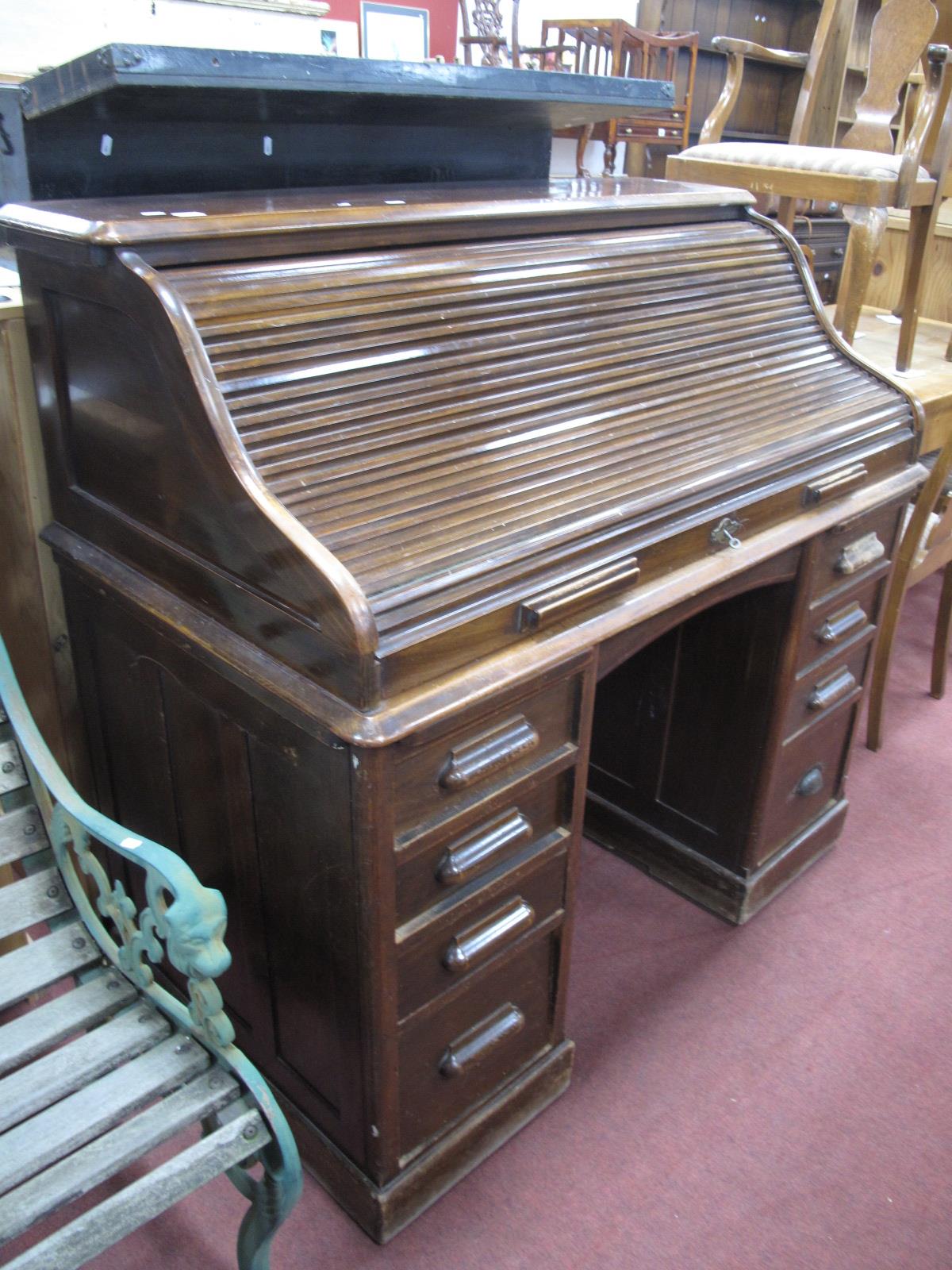An Early XX Century Roll Top Desk ("The Lebus Desk"), with a three shaped tamber, fitted interior,