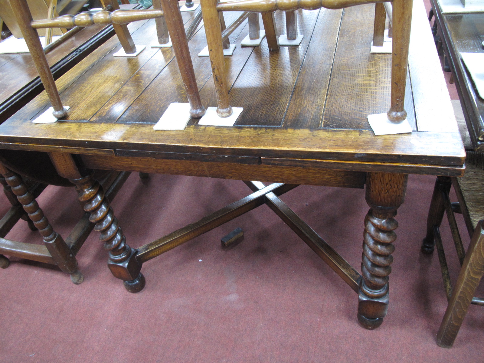 A 1930's Oak Draw Leaf Dining Table, on barley twist supports, and block supports with X stretcher.