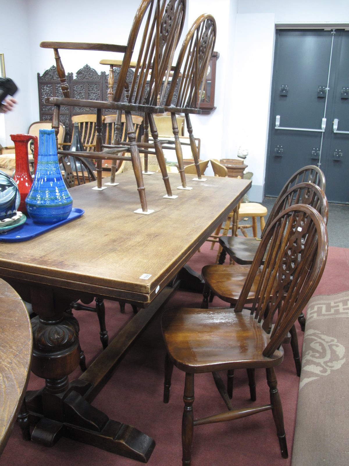 A XX Century Oak Draw Leaf Rectory Table, on cup-cover supports, central stretcher, together with