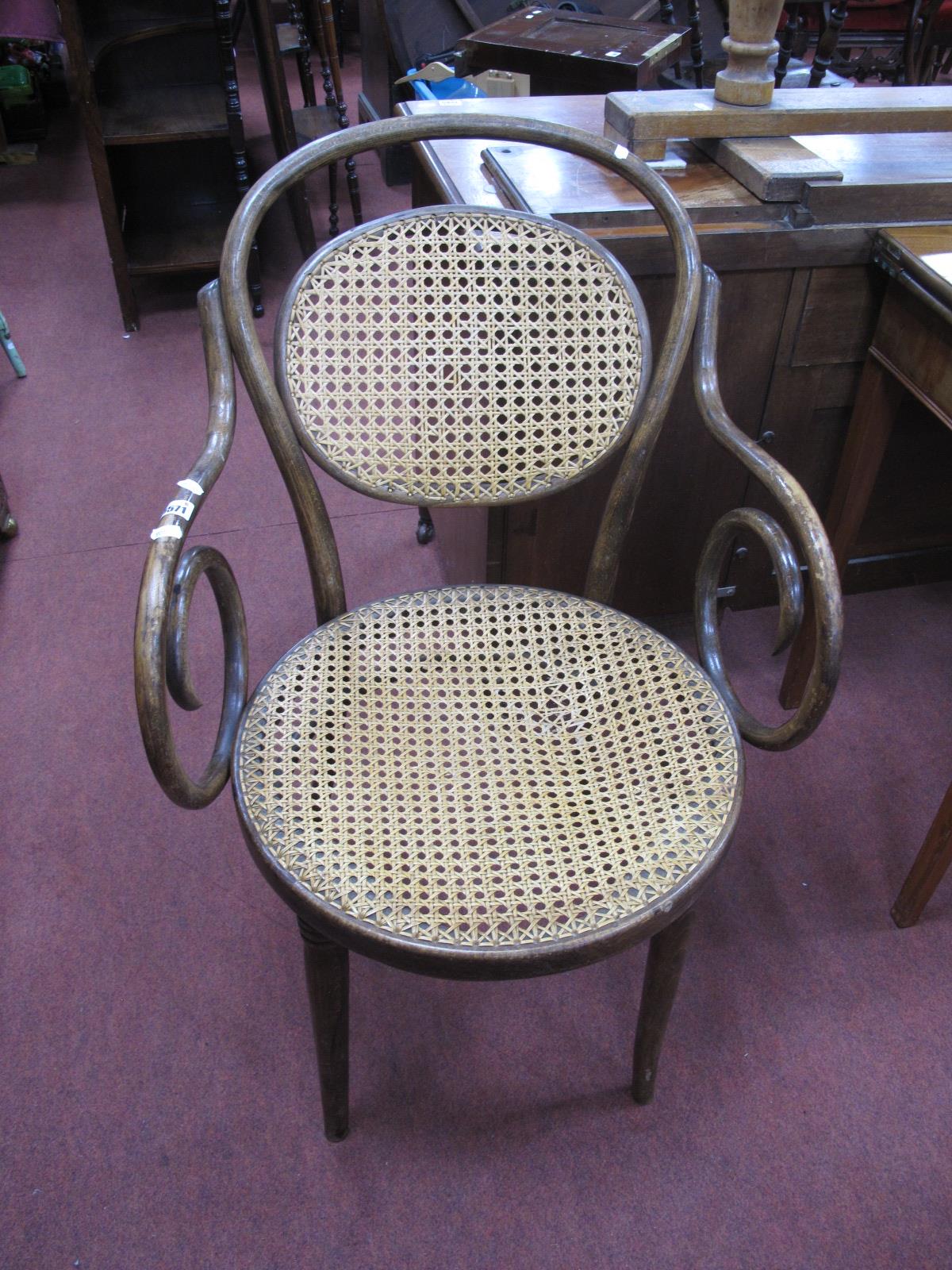 An Early 1900's Bentwood Armchair, with cane seat and back.