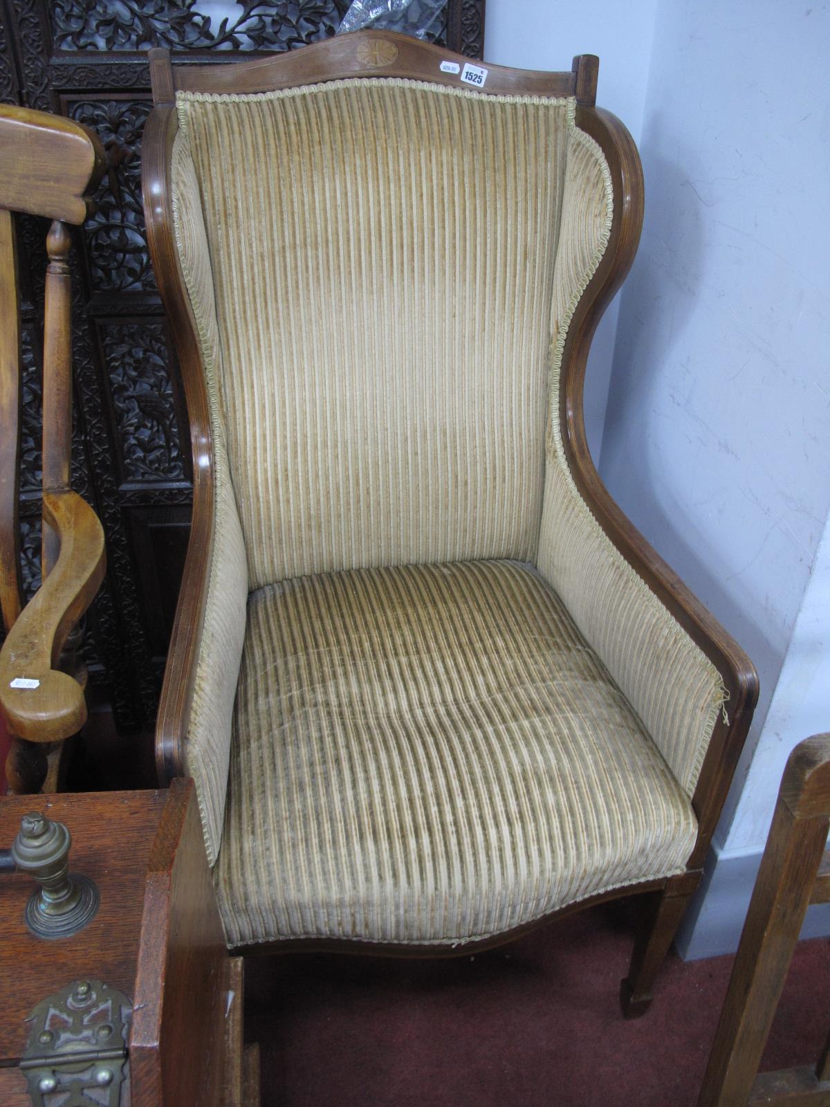 An Edwardian Mahogany Inlaid Wing Chair, with a shaped top rail, with batwing inlay, on tapering