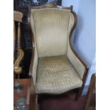 An Edwardian Mahogany Inlaid Wing Chair, with a shaped top rail, with batwing inlay, on tapering