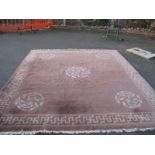 A Chinese Wool Tassled Carpet, with floral motifs, within Swastika border, on brown ground, no