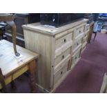 A Pine Chest of Drawers, with six small drawers, on a shaped plinth base, with stud decoration,