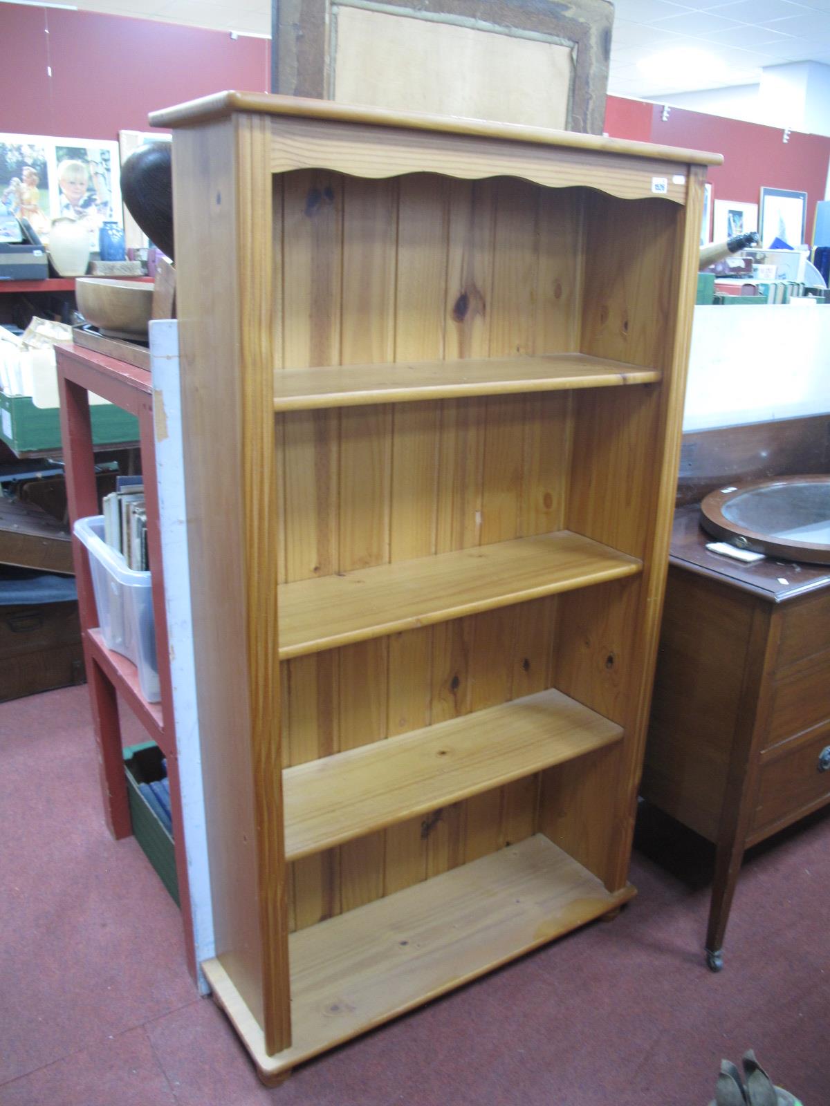 A Pine Bookcase, with four fixed shelves, on bun feet, 84cm wide.