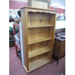A Pine Bookcase, with four fixed shelves, on bun feet, 84cm wide.