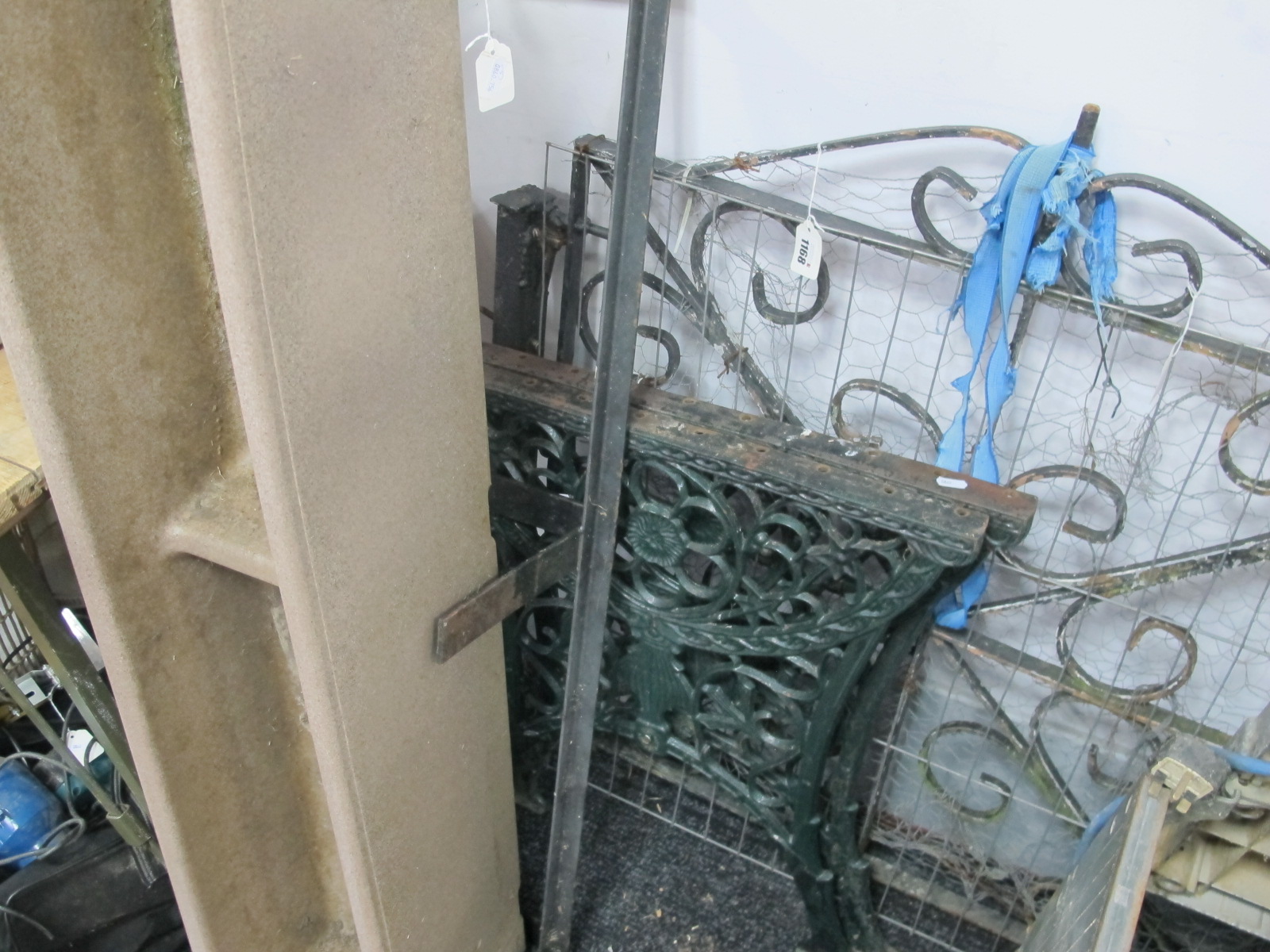 Metal Garden Gate, plastic planter in metal stand, metal table supports.