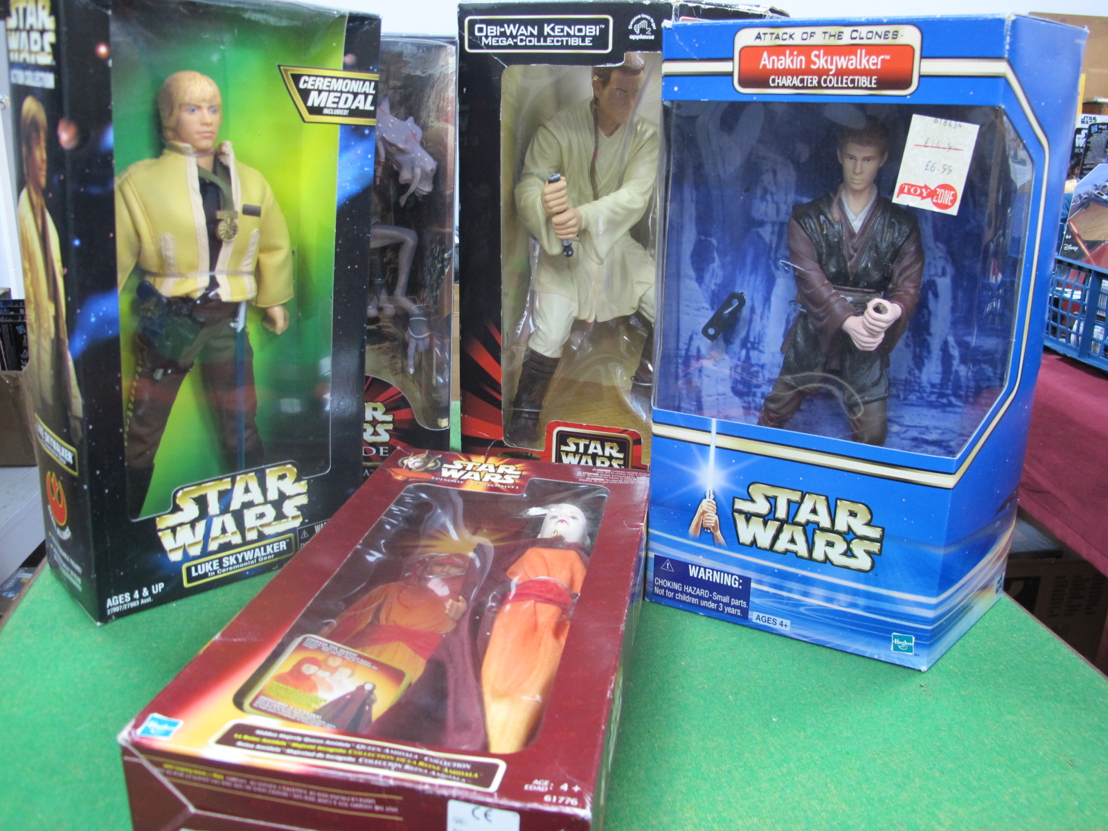 Five Boxed Star Wars Figures, to include Queen Amidala, Anakin Skywalker and three others.