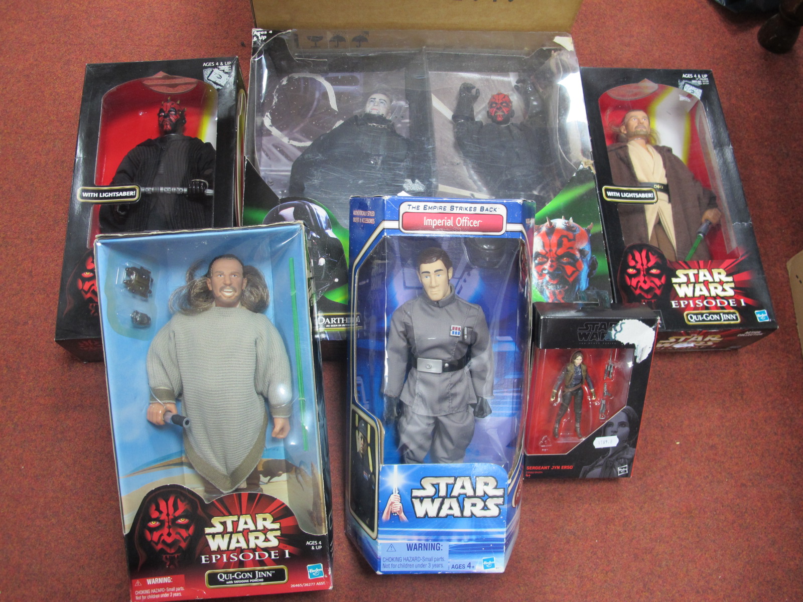 Four Boxed Star Wars Figures, including Que-Gon Jinn, Imperial Officer and two others. Boxed Darth