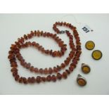 A Tumbled Amber Bead Necklace, together with two pairs of earrings.