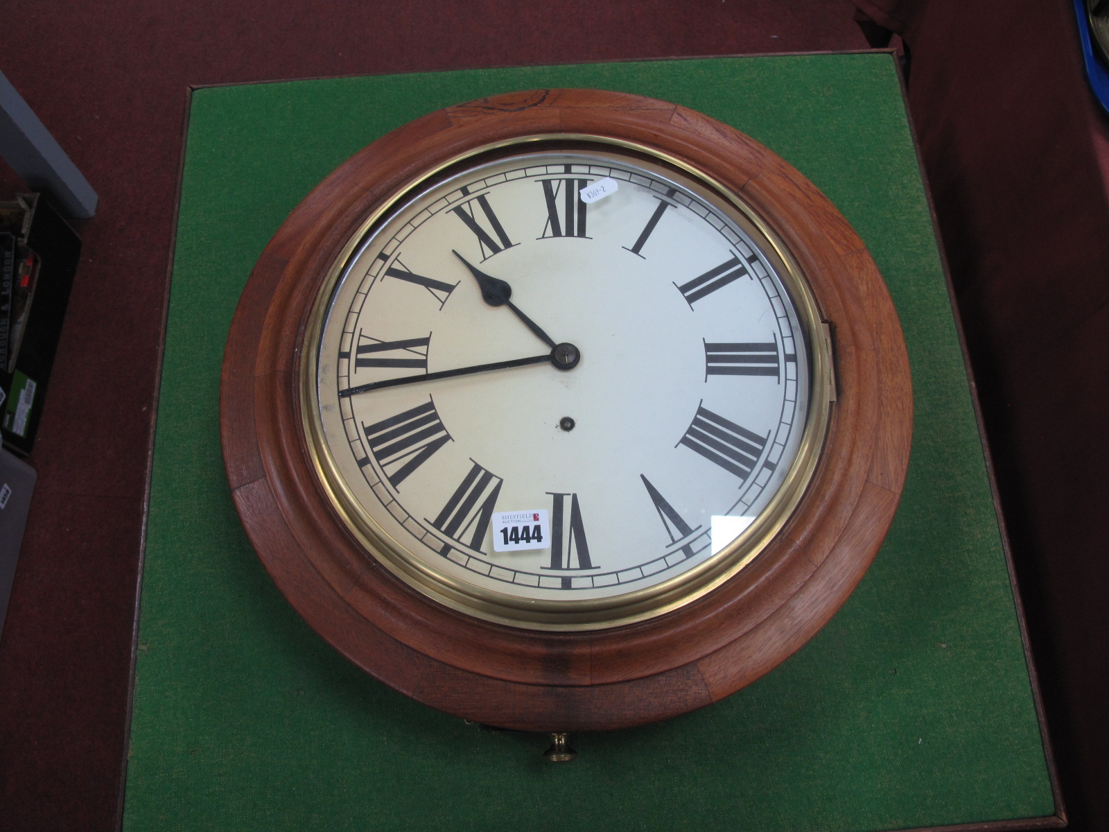 A XX Century Mahogany Wall clock, with a white dial, Roman numerals.