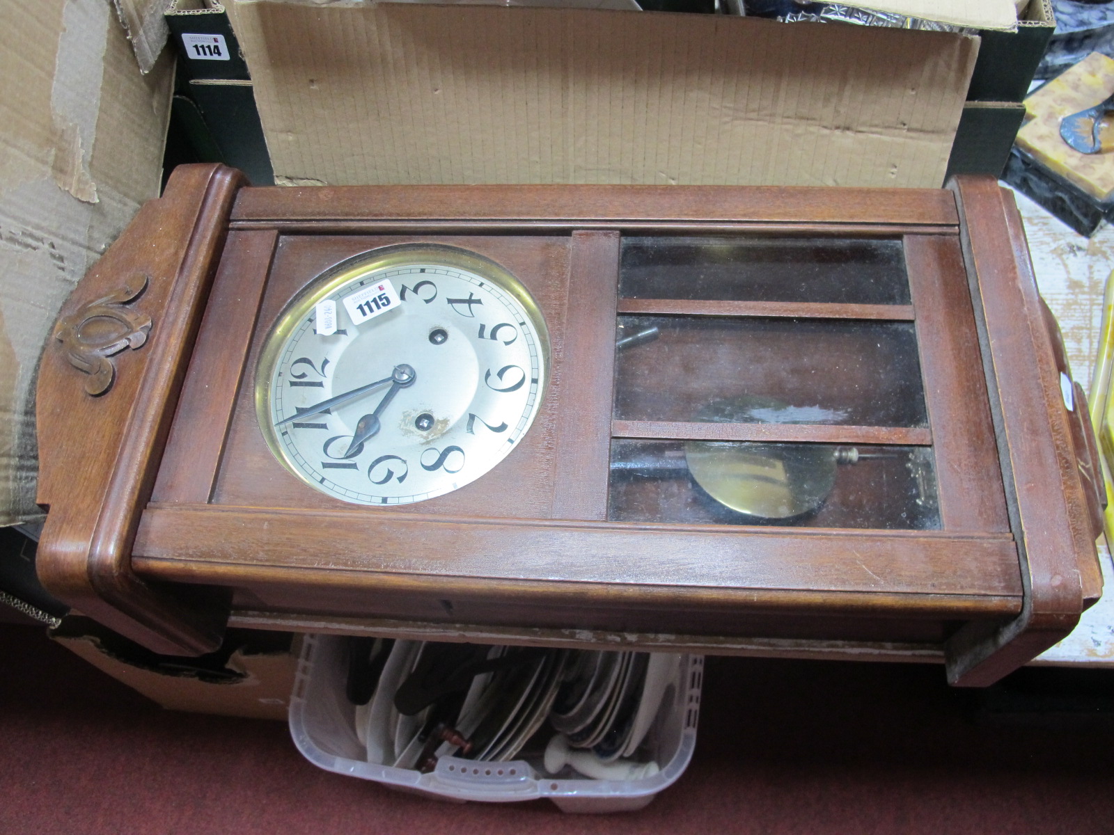 A 1940's Mahogany Wall Clock, with a silver dial, Arabic numbers, shaped base, 65cm wide.