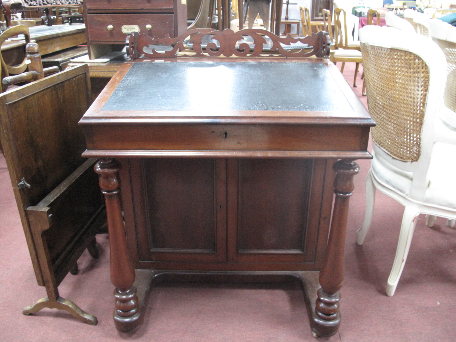 A XIX Century Mahogany Davenport Desk, of elongated form with (damaged) pierced gallery, slope