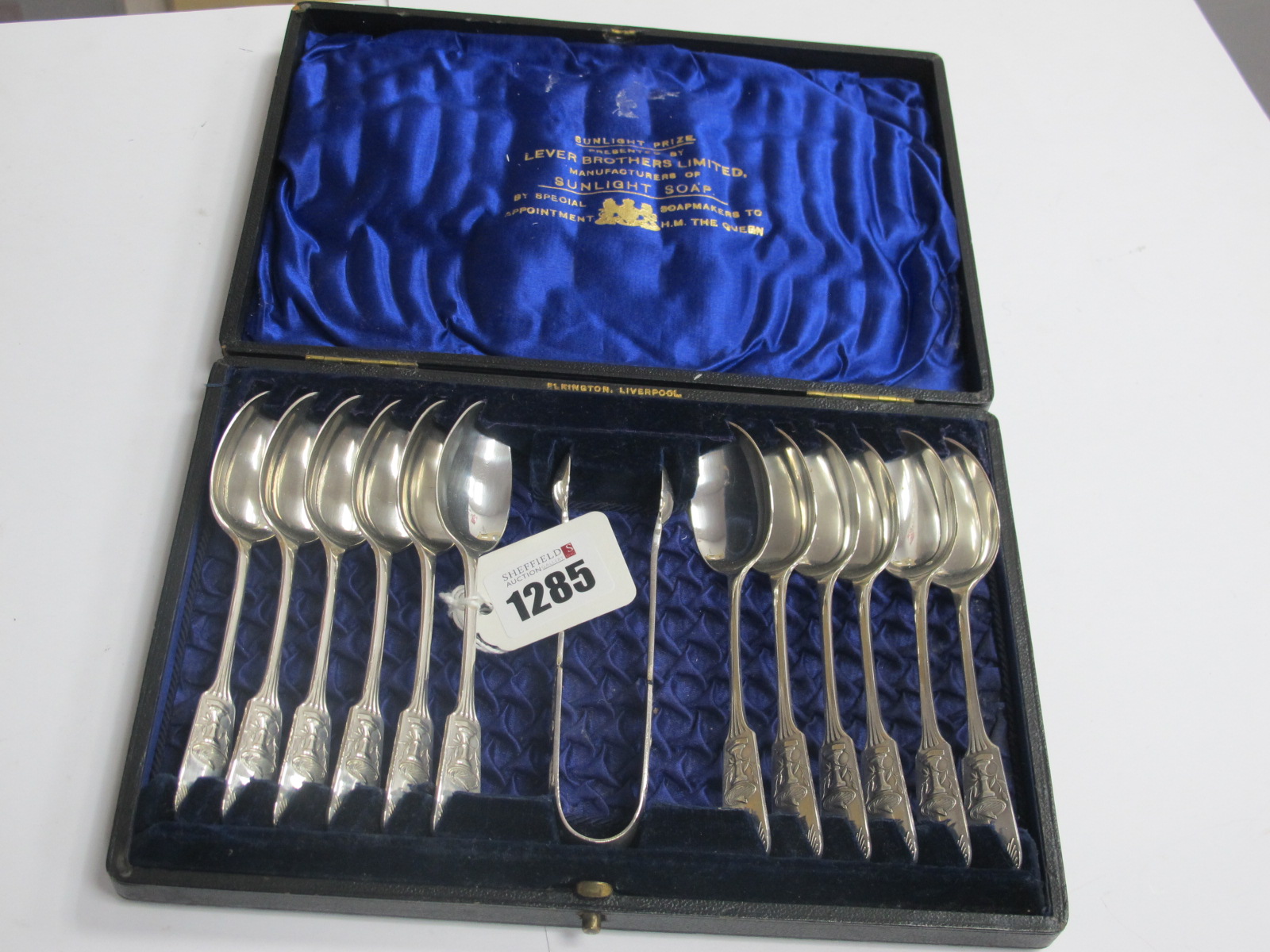 A Cased Victorian Set of Twelve Spoons and a pair of sugar tongs, presented by Lever Brothers Ltd