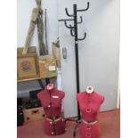 A Black Metal Hat and Coat Stand, on cruciform base, 175cm high, two fabric mannequin torsos. (3).