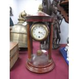 A XX Century Stained Mahogany Mantel Clock, with finial top, column supports, round dial stepped