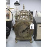 A XVII Style Brass Lantern Clock, with a finial top, circular dial, Roman numerals, with a German