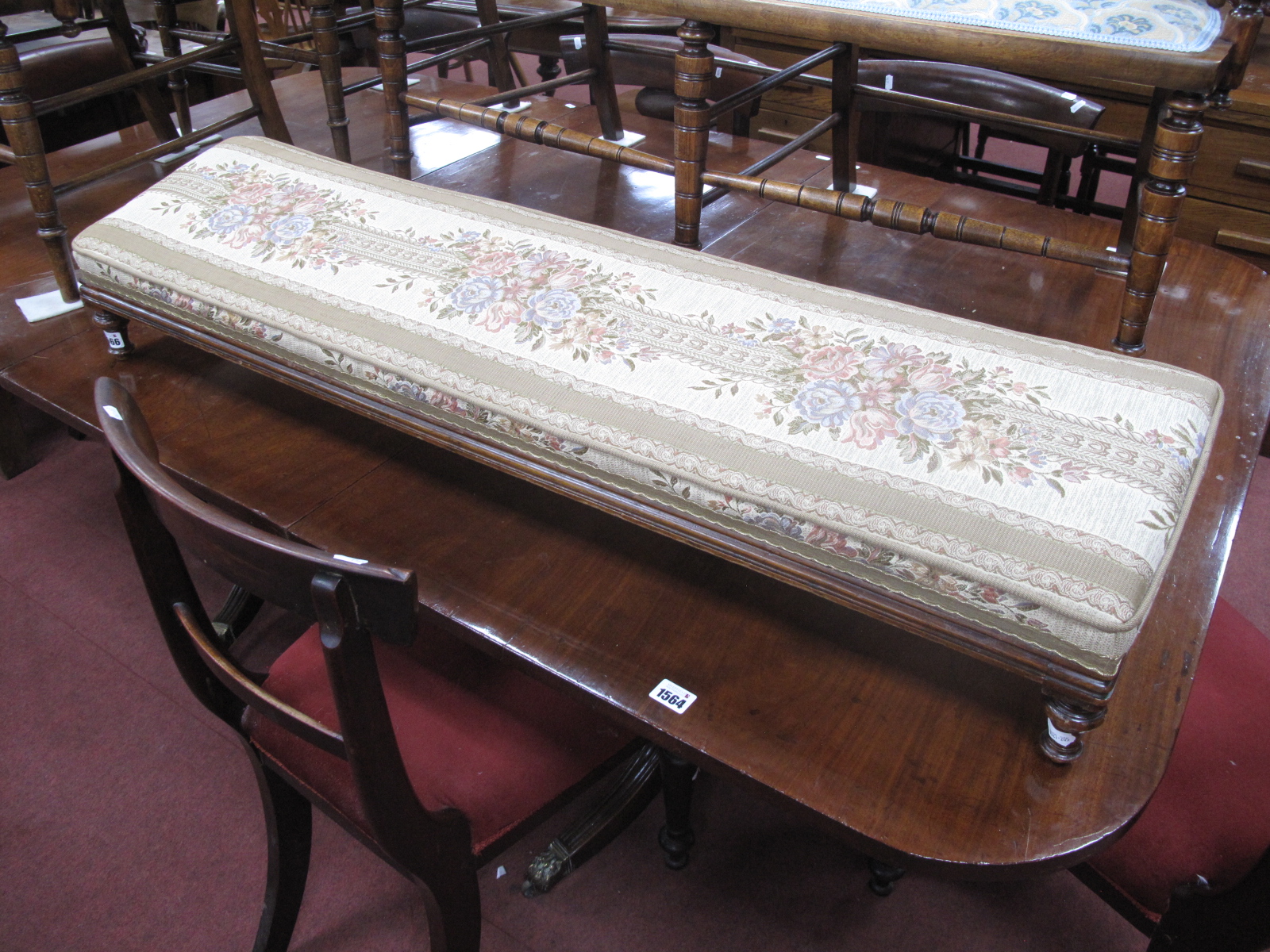 A XIX Century Walnut Rectangular Shaped Footstool, with an upholstered top, on turned supports 113cm