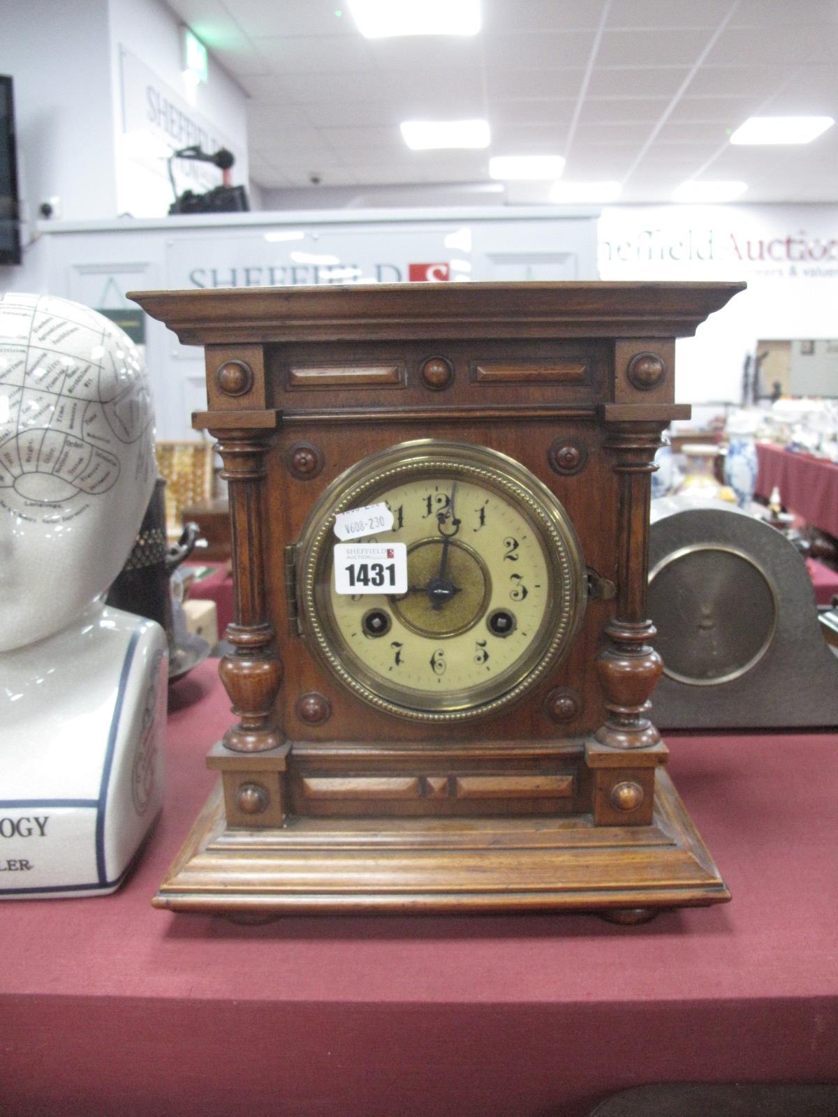 Late XIX Century Walnut Mantel Clock, with a circular dial, split balusters, stepped base, bun feet,