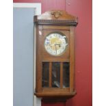 A 1940's Mahogany Wall Clock, with a silver chapter ring, glazed door, 65cm wide.