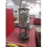 A Miners Lamp by Protector Lamp & Lighting Co, Eccles, 23cm high with handle down.