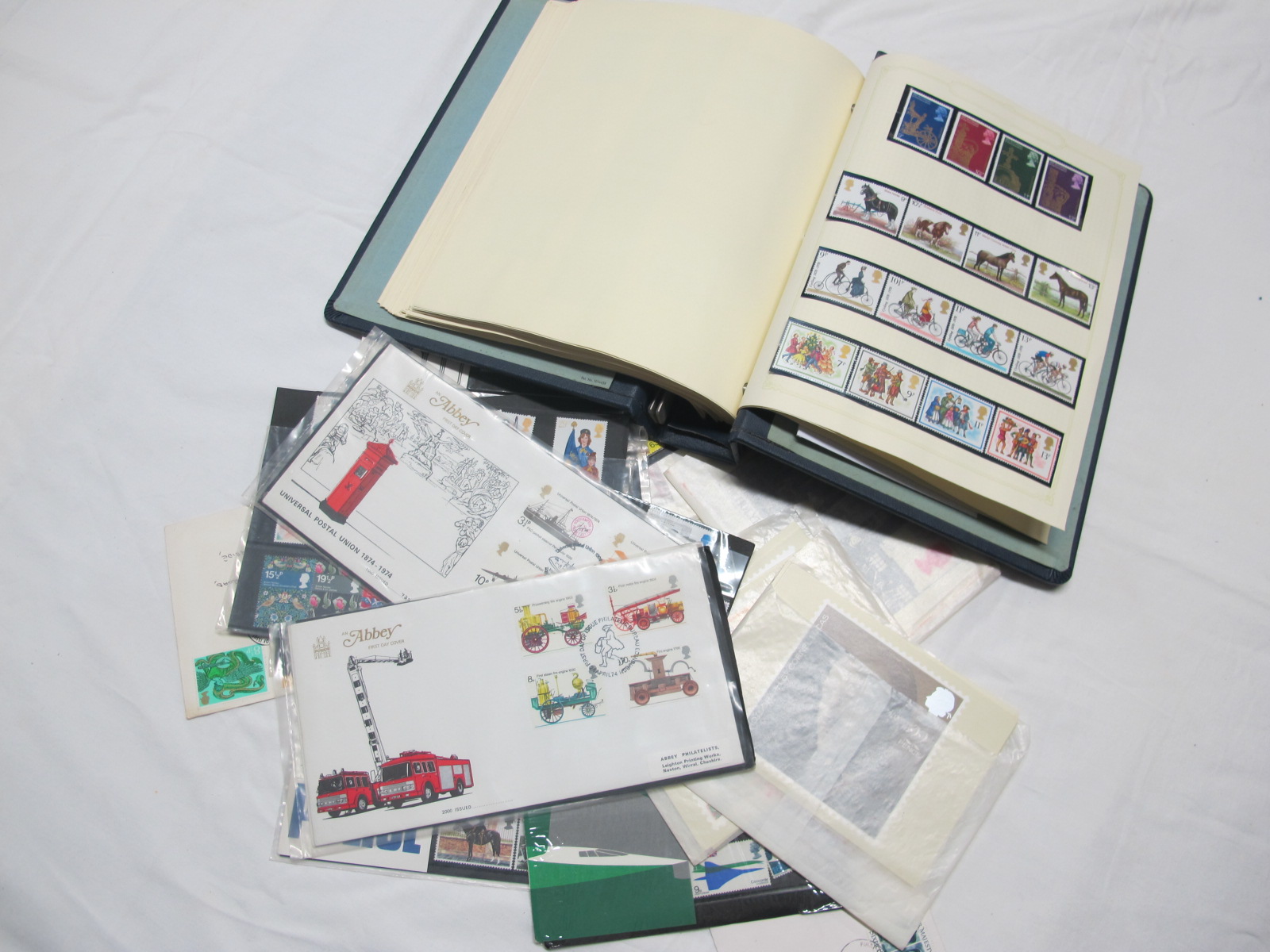 A Collection of GB Mint and Used Stamps, in an album and presentation packs.