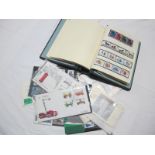 A Collection of GB Mint and Used Stamps, in an album and presentation packs.