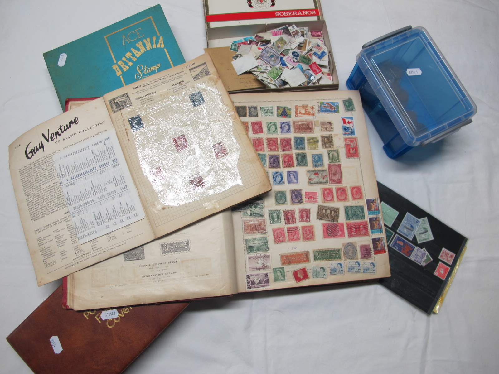 A Box Containing a Mixed Collection of Stamps, of the World FDC's, in an album and a Stanley Gibbons