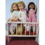 A 1960's Palitoy Doll, and other dolls in a cot.