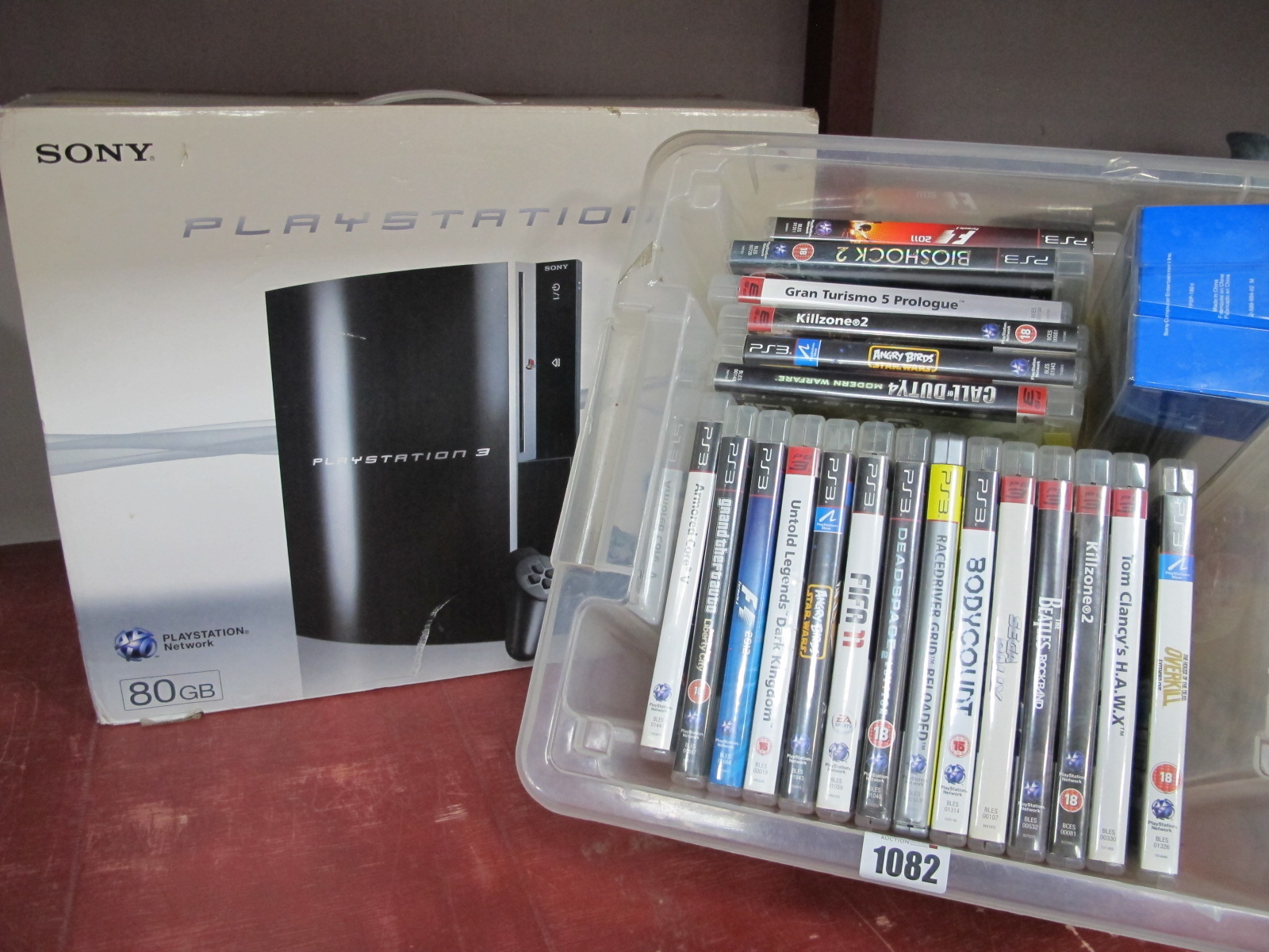 PlayStation 3 (untested sold for parts only), plus twenty PS3 games, car adaptor.