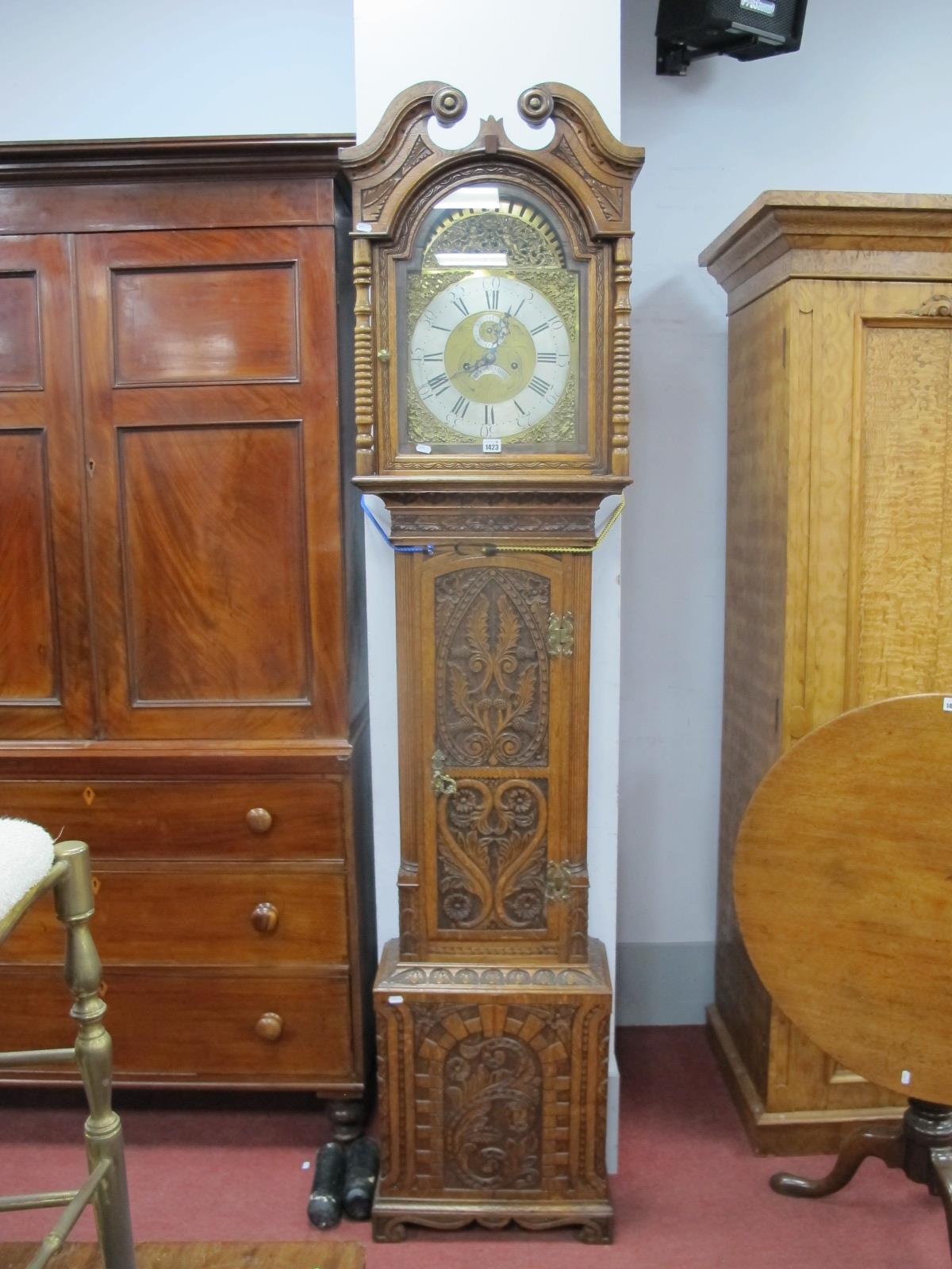 An XVIII Century and Later Carved Oak Eight-Day Longcase Clock, the hood with swan neck pediment and