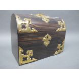 A Mid XIX Century Coromandel Box, of domed rectangular form with elaborate brass mounts and oval