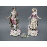 A Pair of XVIII Century Porcelain Figures of a Lady and Gentleman, each standing before a bocage