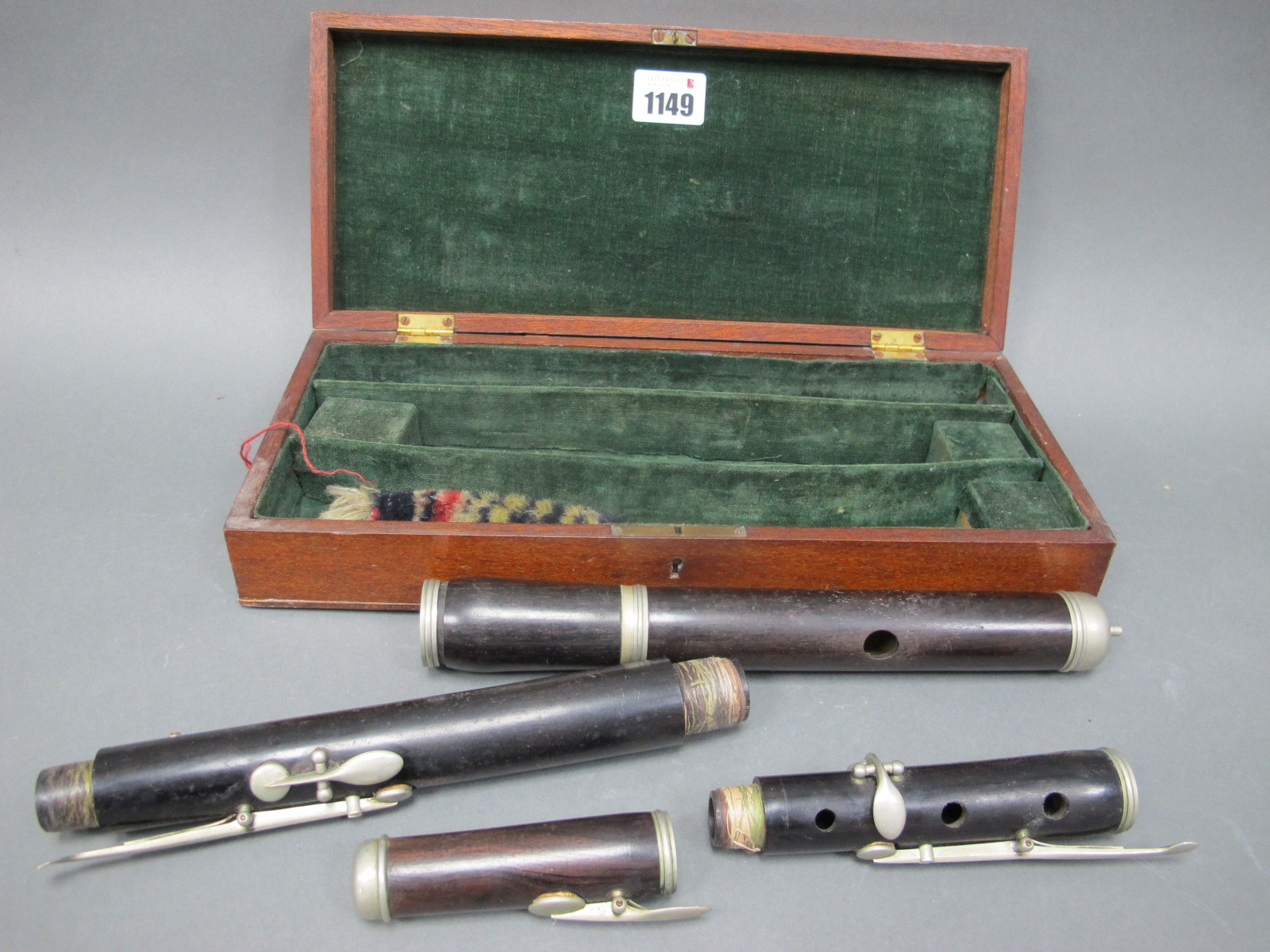 An Early XX Century Rosewood Flute, with white metal keys and mounts, in original fitted wood case,