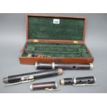 An Early XX Century Rosewood Flute, with white metal keys and mounts, in original fitted wood case,