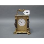 A Late XIX Century French Gilt Metal Carriage Clock, elaborately cast with vines and foliage, the
