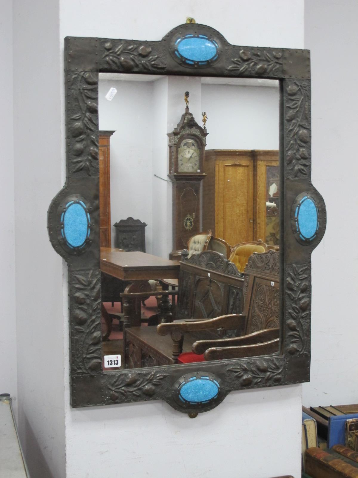 An Art Nouveau Pewter Framed Mirror, of shaped rectangular form, embossed with fruiting foliage