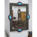 An Art Nouveau Pewter Framed Mirror, of shaped rectangular form, embossed with fruiting foliage