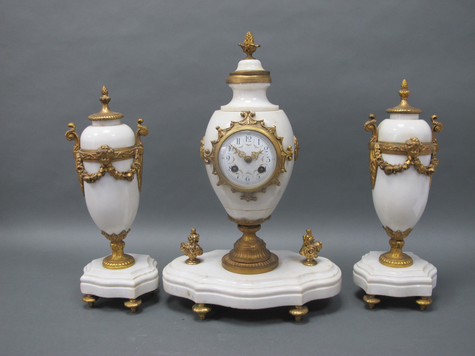 A Late XIX Century French Clock Garniture, the clock with white alabaster case with ormolu mounts,