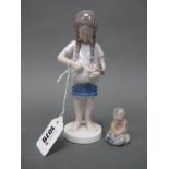 A Royal Copenhagen Porcelain Figure of a Girl Holding a Kitten in Her Dress, circular base,