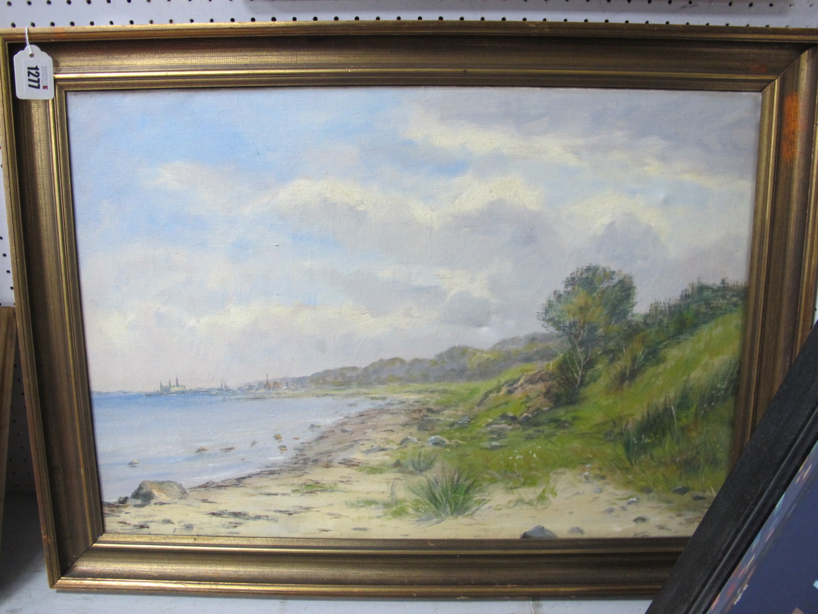 XX CENTURY CONTINENTAL SCHOOL Beach Scene, with buildings in the distance, oil on canvas, signed R.