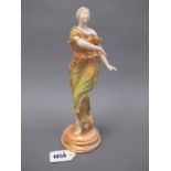 A Royal Worcester Porcelain Figure of a Dancing Lady, wearing a long flowing dress in green and