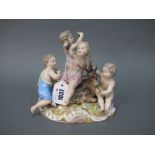 A Late XIX Century Meissen Porcelain Model of Four Cherubs, representing 'Autumn', each holding