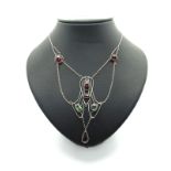 An Arts & Crafts Style Necklace, of openwork sinuous design, cushion and oval collet set, suspending