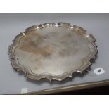 A Hallmarked Silver Tray, Carrington & Co, London 1914, of shaped circular form, raised on four