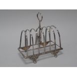 A Victorian Hallmarked Silver Seven Bar Toast Rack, Sheffield 1881, with shaped central loop handle,