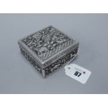 An Indian Square Cigarette Box, allover detailed in relief with wild animals, 8.3cm wide.