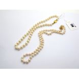 A Modern Uniform Single Strand Pearl Bead Necklace, knotted to clasp stamped "375"; Together with