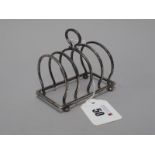 A Hallmarked Silver Five Bar Toast Rack, Walker & Hall, Birmingham 1921, on four bun feet (60grams).