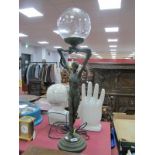 An Art Deco Style Lamp, as a bronze effect lady holding a lamp above raised arms, on circular